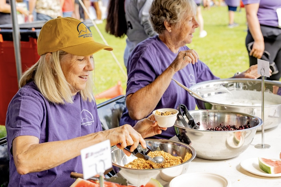 Tin Cup Volunteers serving food